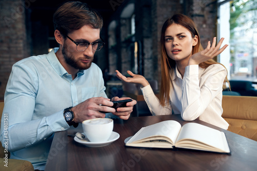 work colleagues in a cafe sit at the breakfast table communication