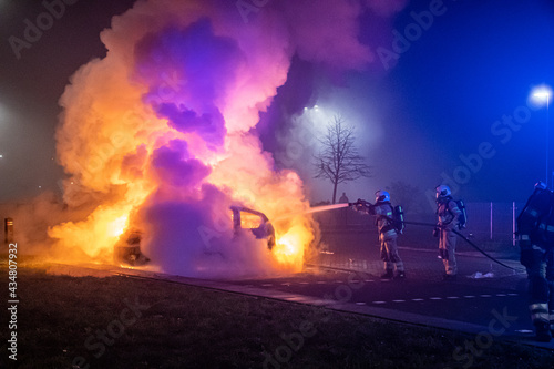 Car on fire at night