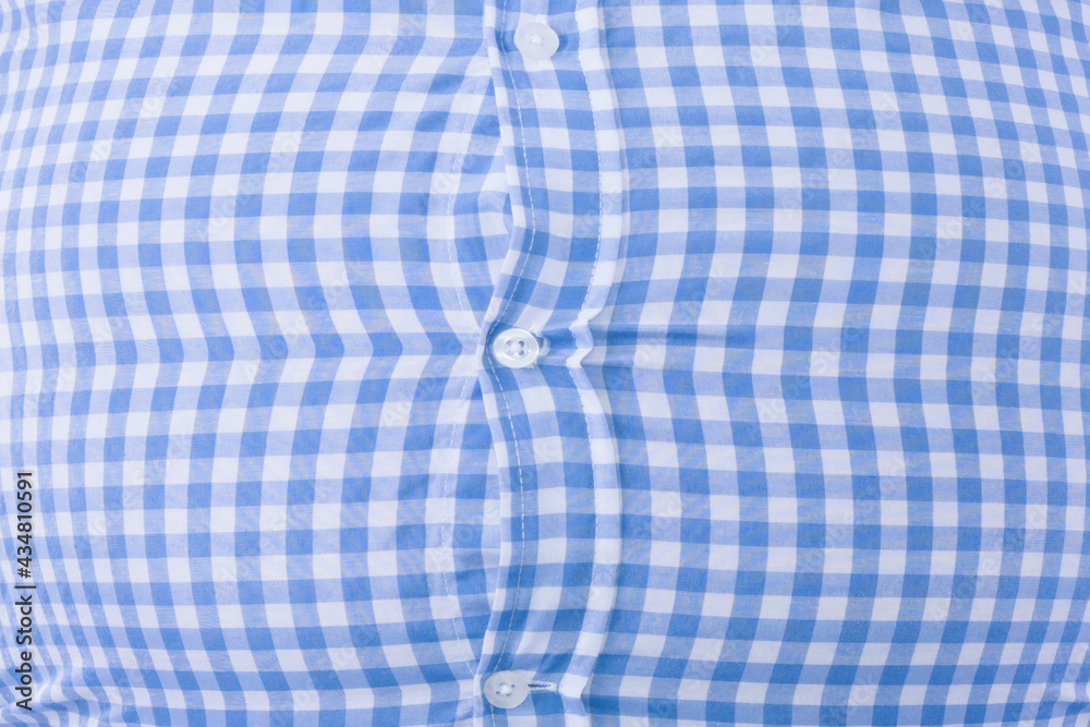 Close up of a tight shirt of a man with overweight, typical photo for beer belly: Selective focus. Close up of a tight shirt of a man with overweight, typical photo for beer belly: Selective focus.