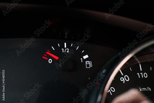 Dashboard of a car indicating that it is running out of fuel reserve