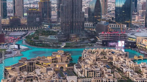 Dubai Downtown day to night transition timelapse with music fountain show near Burj Khalifa and other towers close up view from the top before new year celebration in Dubai, United Arab Emirates photo