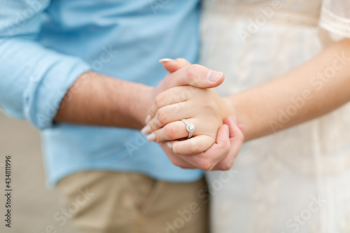 Couple holding hands and dancing. Holding hands. Dancing. Wedding ring. Engagement ring.