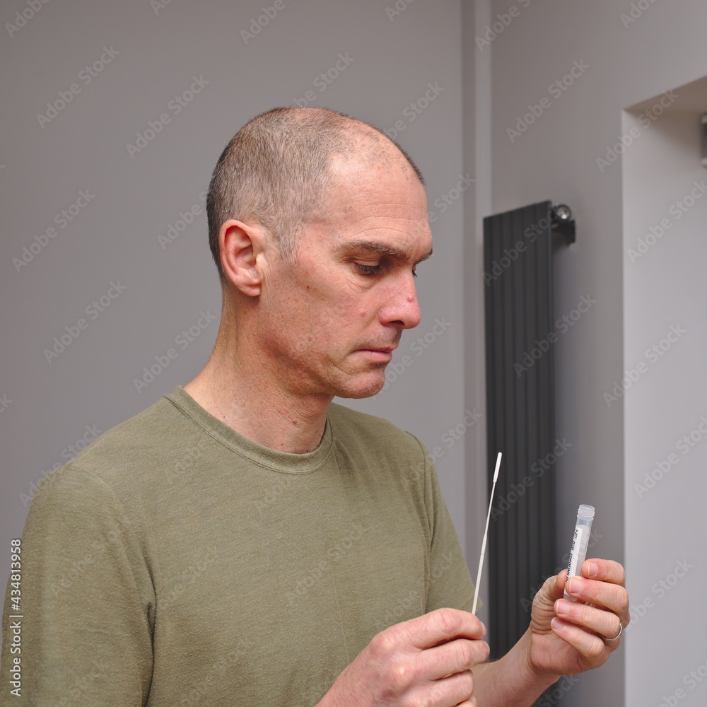 Man self testing at home for COVID19 coronavirus Man self testing at home for COVID19 coronavirus