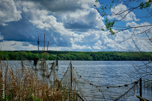 Fischnetze am Ufer der Havel. Im Hintergrund die Pfaueninsel und der Fernmeldeturm Schäferberg photo