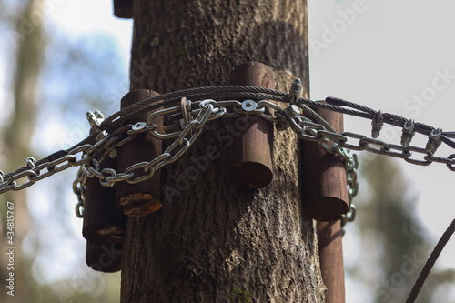 Fastening in the rope park.Mechanisms for securing ropes and wooden elements.Sports amusement park for children and adults.A reliable and safe route above ground level.Route between trees