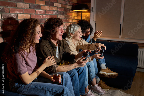 Crazy Young People Friends Enjoying Playing Videogame Game Console, Resting At Home, Resting At Home, In Casual Clothes, Games Console