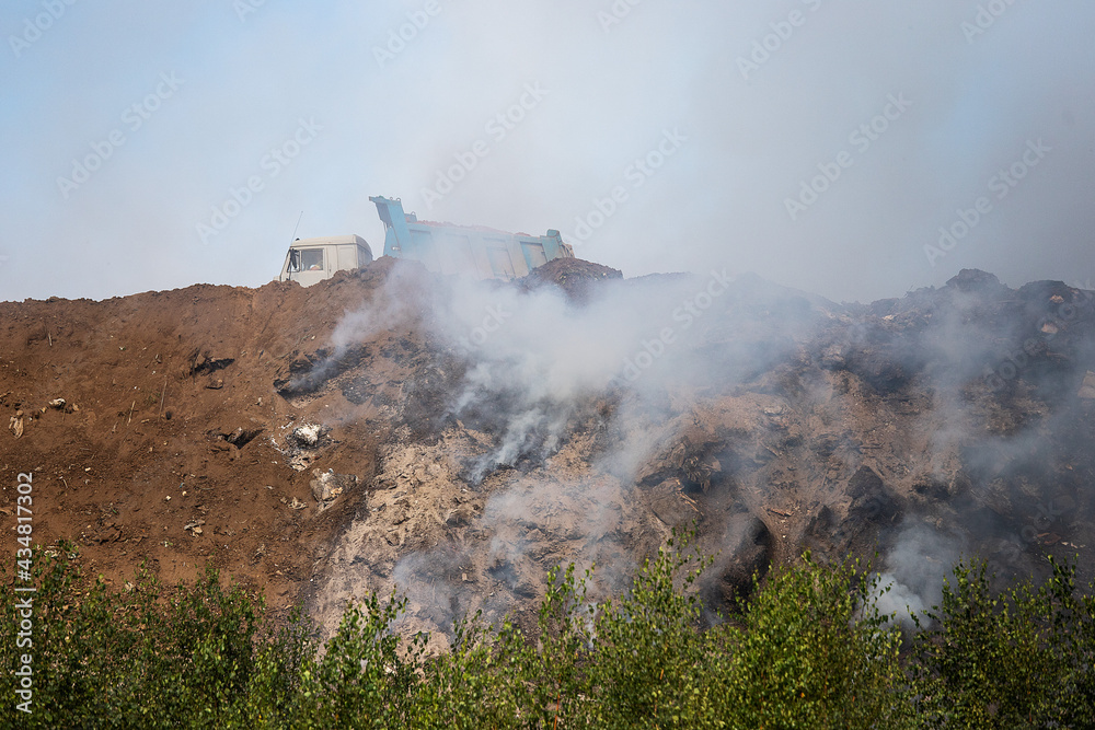 firefighters on the ashes. completed work on extinguishing the fire. analysis of the rubble of burnt pieces of wood on the site of the burned house. smog and the smell of burning
