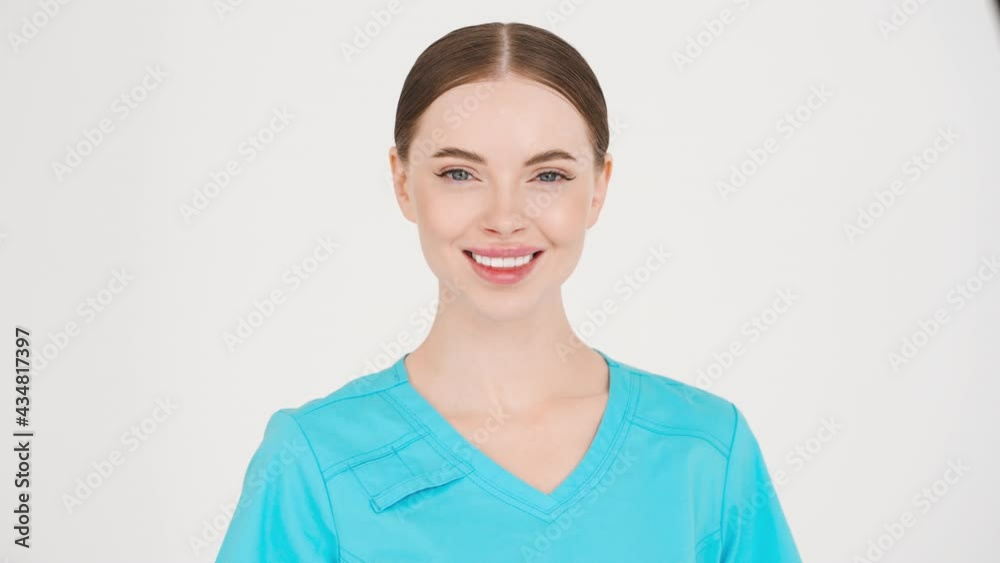 Medic woman doctor in blue professional uniformstudio face portrait happy teeth smile looking camera Medic woman doctor in blue professional uniformstudio face portrait happy teeth smile looking camera