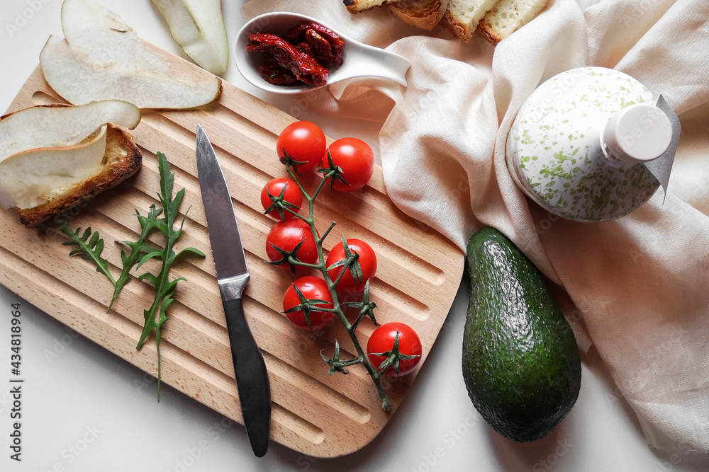 Healthy food. Avocado sandwich. Rye bread with bran, cherry tomatoes, avocado, lettuce, on a wooden board