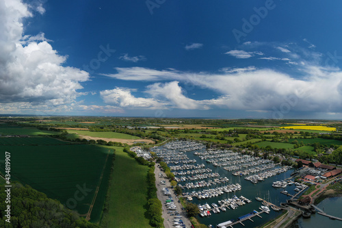 Aerial photo of Chichester Marina full of yachts and boats a popular sailing destination in the beautiful countryside of West Sussex in Southern England.