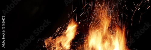 Flames Of Fire And Sparks Isolated On Black Background. Abstract Flaming Background. Magic Fiery Wallpaper. Flying Sparks Background, Closeup View. Bonfire Flaming In The Night. Energy Concept.