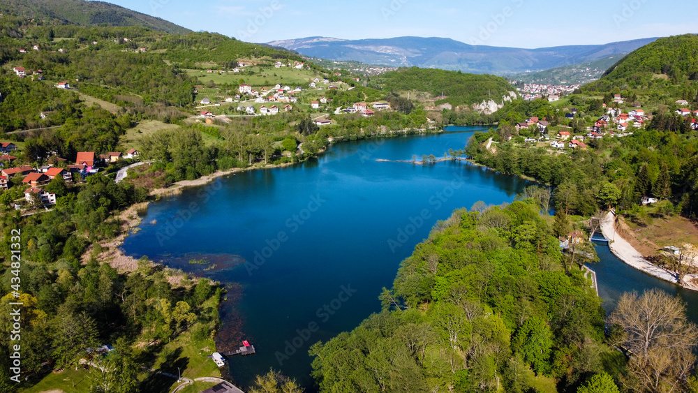 Aerial drone view of lake, villages and forest in early spring. Plivsko jezero, Jajce, Bosnia and Herzegovina.
