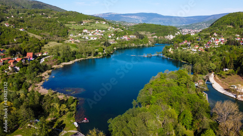 Aerial drone view of lake, villages and forest in early spring. Plivsko jezero, Jajce, Bosnia and Herzegovina. 