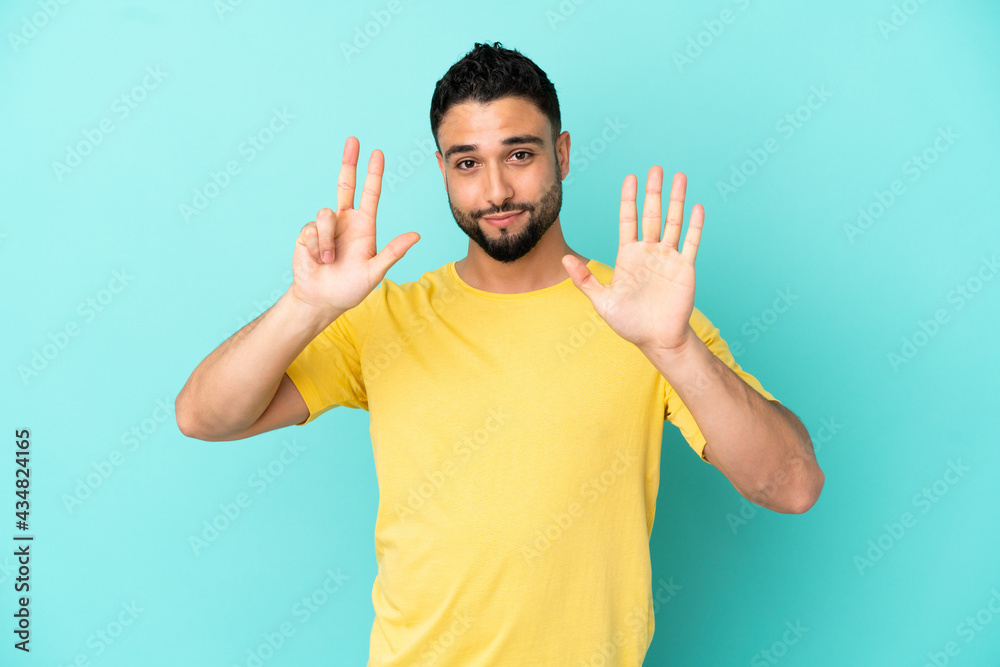 Young arab man isolated on blue background counting eight with fingers Young arab man isolated on blue background counting eight with fingers