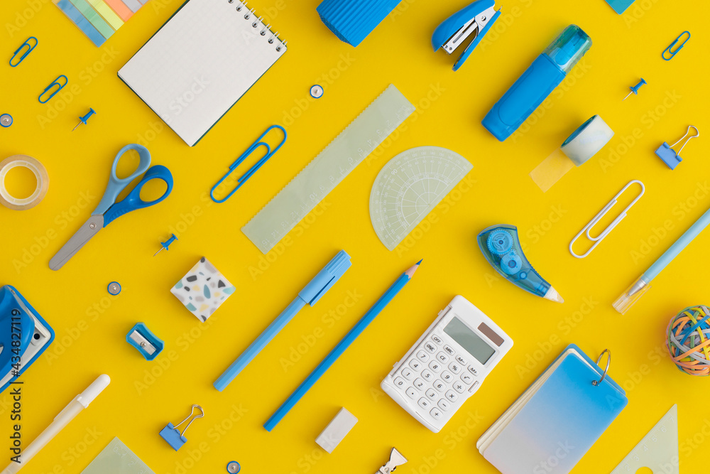 Pattern composition of school stationery on a yellow background. Top view. Flat lay. Back to school concept.