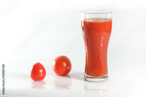 Fresh tomatoes and a glass full of tomato juice