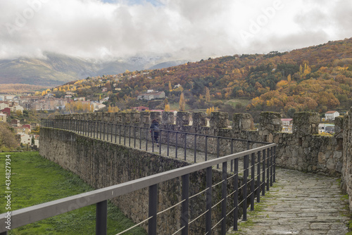 Walkway surrounded by handrails and walls in a park under a cloudy sky in autumn in Bejar, Spain photo