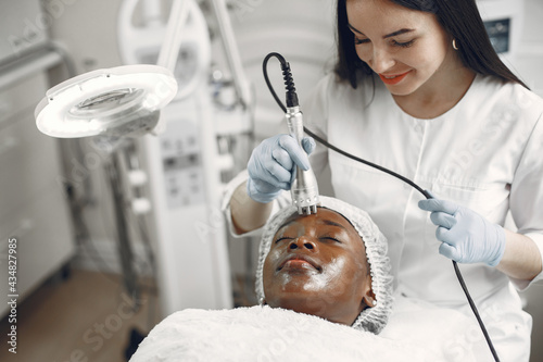 Photography Girl doing facial procedures to beautician