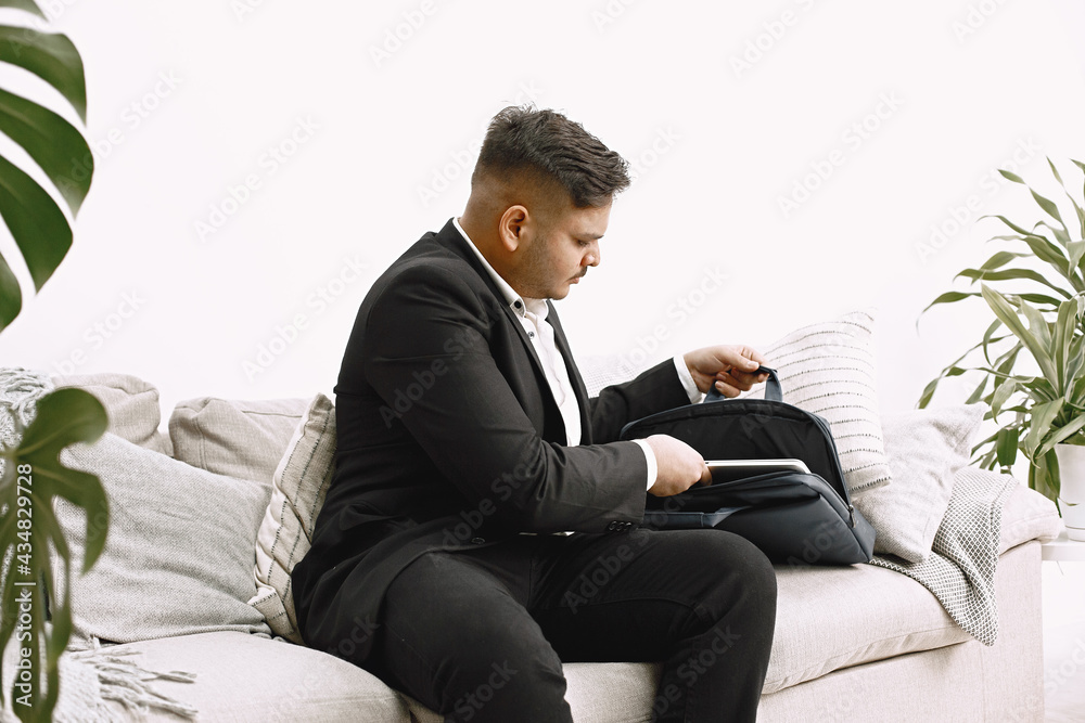 Handsome young man using laptop computer at home