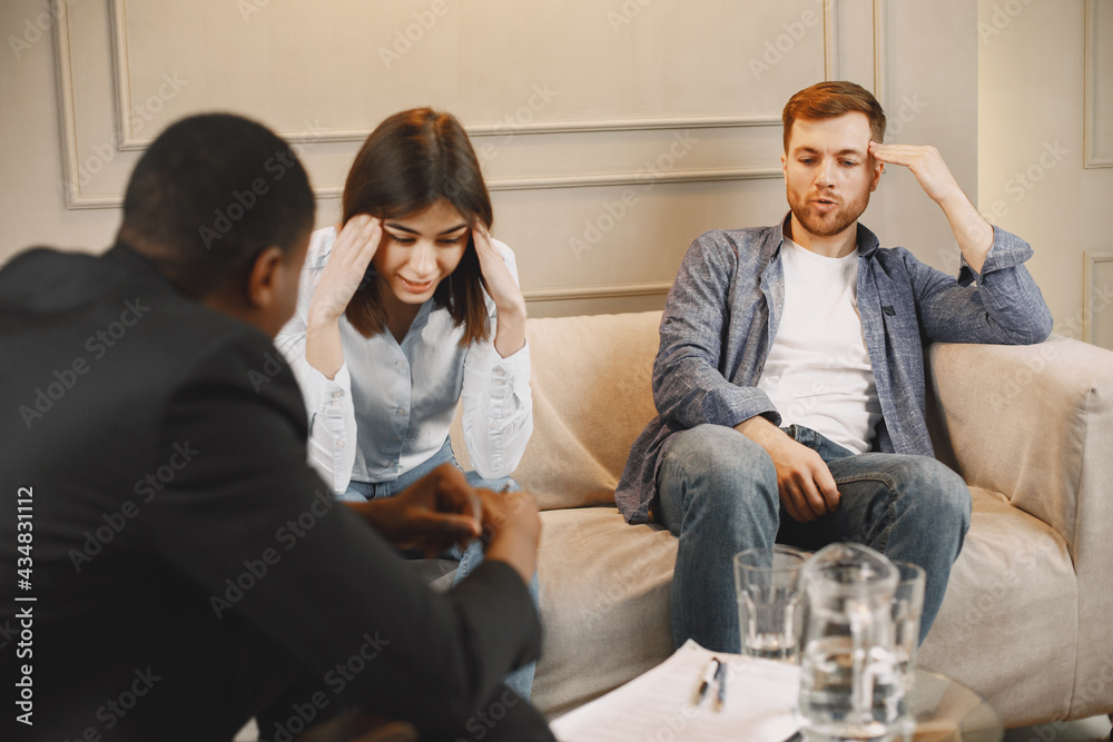 Fototapeta premium Couple at pshycologist appointment sitting in modern office