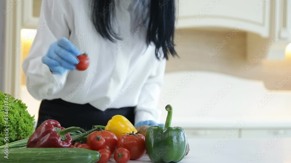 woman cutting vegetables in kitchen woman cutting vegetables in kitchen