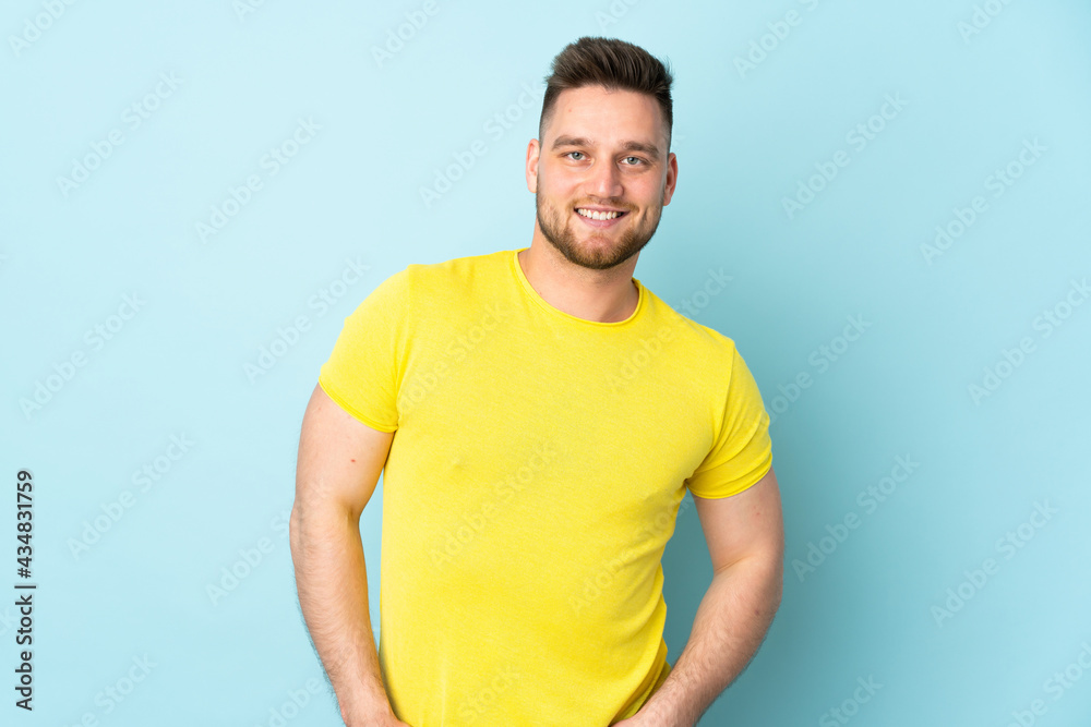Russian handsome man isolated on blue background laughing Russian handsome man isolated on blue background laughing