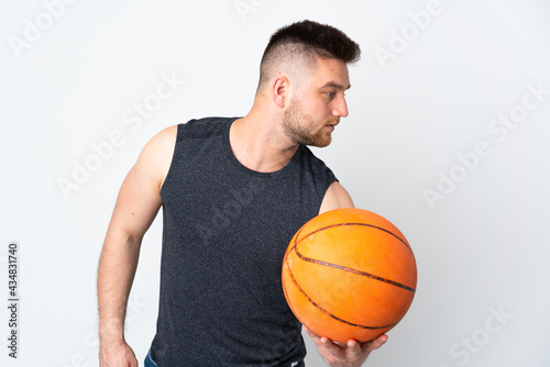 Russian handsome man isolated on white background playing basketball © luismolinero