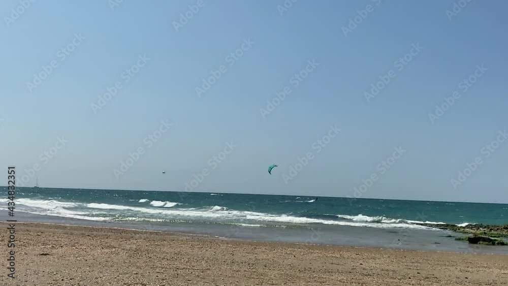 Two kite surfers glide on the sea waves. HD Two kite surfers glide on the sea waves. HD