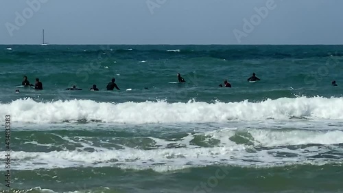 Serfers and serfing at Tel Baruch Mediterranean sea beach. Tel Aviv, Israel.  HD