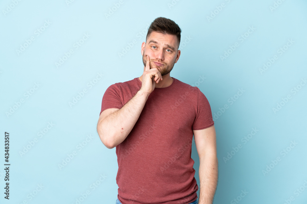 Russian handsome man over isolated background and thinking Russian handsome man over isolated background and thinking