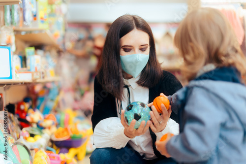 Mother and Toddler Daughter Shopping for Toys in a Store © nicoletaionescu