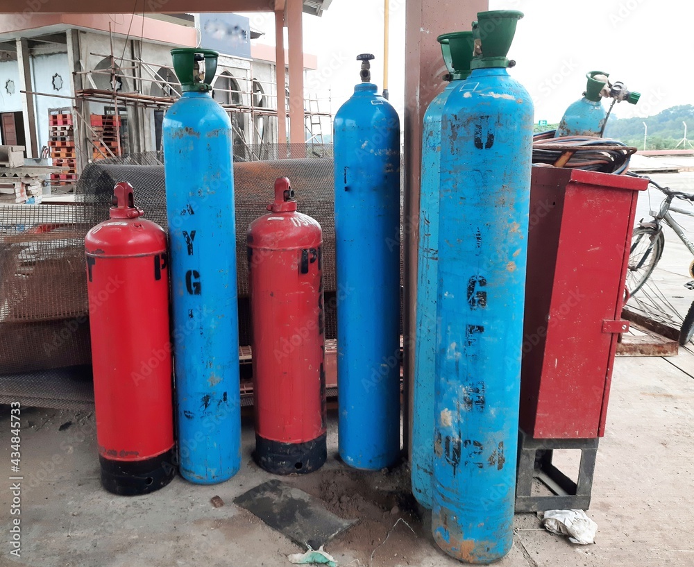 oxygen cylinder which is blue and acetylene tube which is red, commonly used for cutting iron work, oxygen cylinder which is blue and acetylene tube which is red, commonly used for cutting iron work,