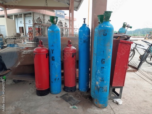 oxygen cylinder which is blue and acetylene tube which is red, commonly used for cutting iron work,
