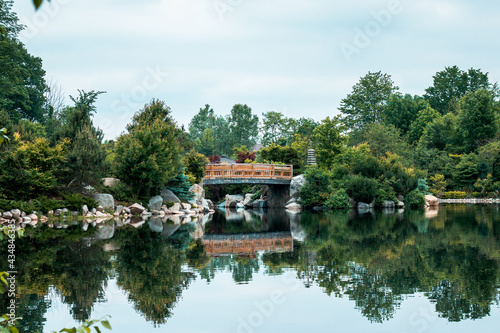 The bridge at the japanese garden reflecting in the lake on a still day