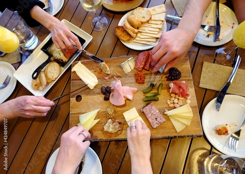 People sharing a charcuterie platter