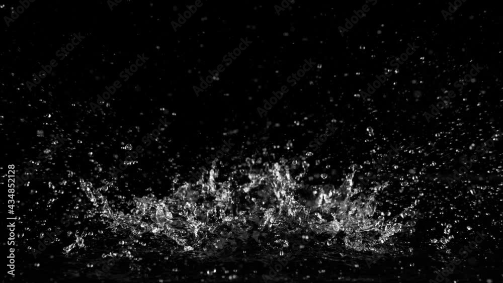 Super slow motion of splashing water isolated on black background. Filmed on high speed cinema camera, 1000 fps.