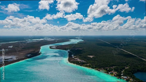 Aerial drone timelapse of Bacalar lagoon in Quintana Roo, caribbean part of México. Mayan region on a dense jungle. Cloudy day with beautiful turquoise colors in the water.