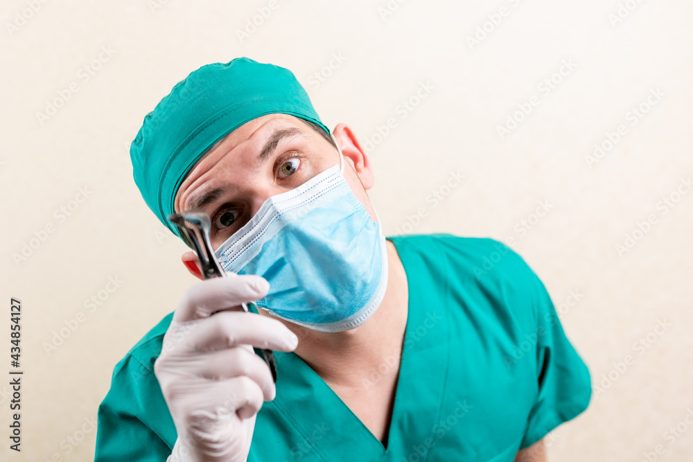 Doctor ENT, wearing a mask and glasses, with a device in his hands. Doctor ENT, wearing a mask and glasses, with a device in his hands.