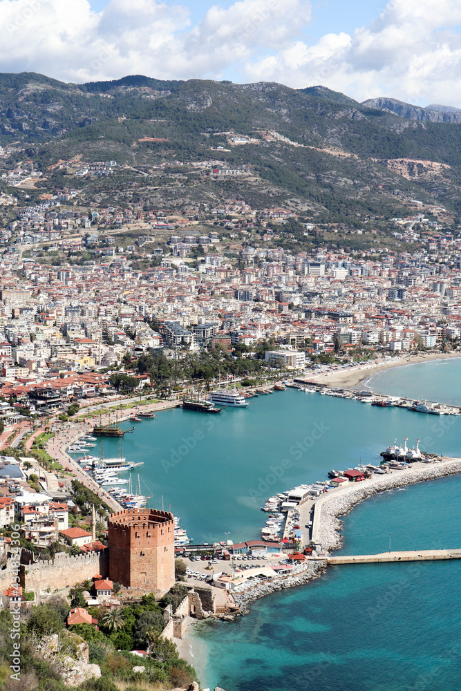 panoramic view to the city of Alanya, marina, sea and mountains from the top of the fortress wall