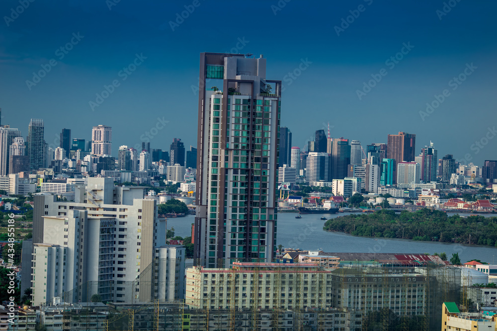 Panorama background of city views, with colorful twilight sky, high-rise buildings (condominiums, offices, expressways) and blurred lights from roads and traffic.