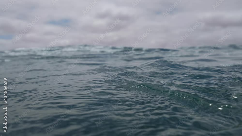 POV emerging from underwater in slow motion.