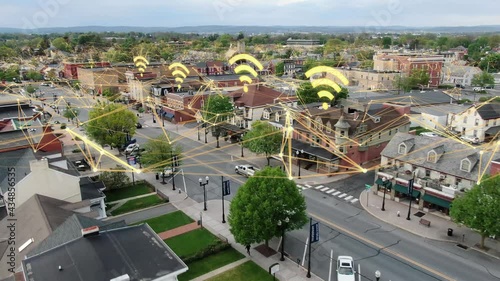 Internet web and data speed signals overlays small town in USA. Rural public broadband expansion and community access. photo