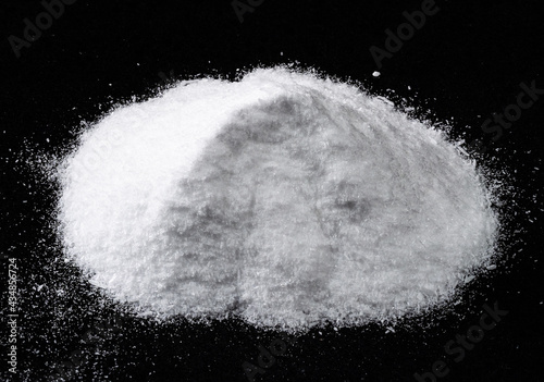 pile of dextrose crystalline sugar on black