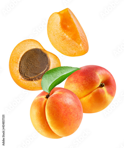 Flying ripe apricot with green leaves isolated on white background
