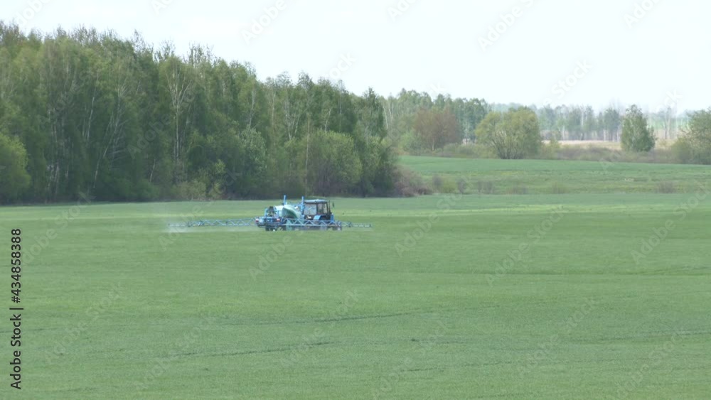 A farmer sprays a field of spring wheat with a tractor and a mamut topline sprayer. A farmer spraying on the spring wheat field with tractor and a mamut topline sprayer.
A farmer sprays a field of spring wheat with a tractor and a mamut topline sprayer. A farmer spraying on the spring wheat field with tractor and a mamut topline sprayer.