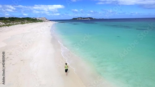 Women Running along Shore of Hamilton Beach in Queensland, Australia, Forward Aerial photo