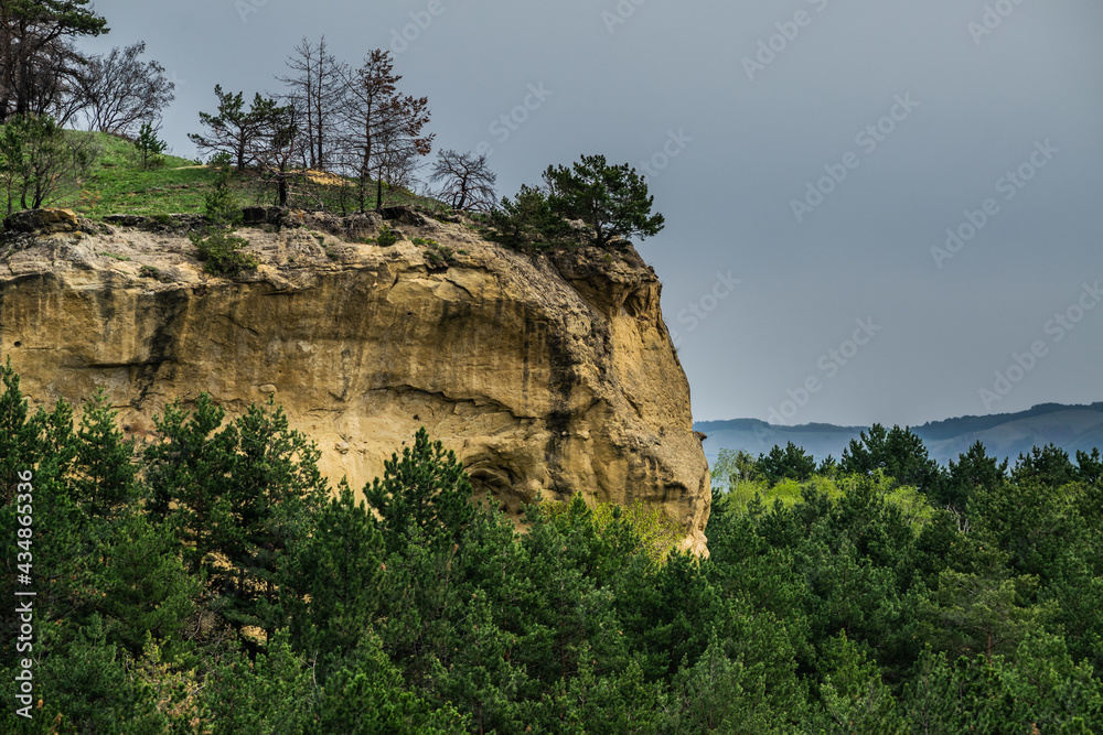 mountain cliff over green pine forest during cloudy day, Kislovodsk city, caucasus mountains, Russia