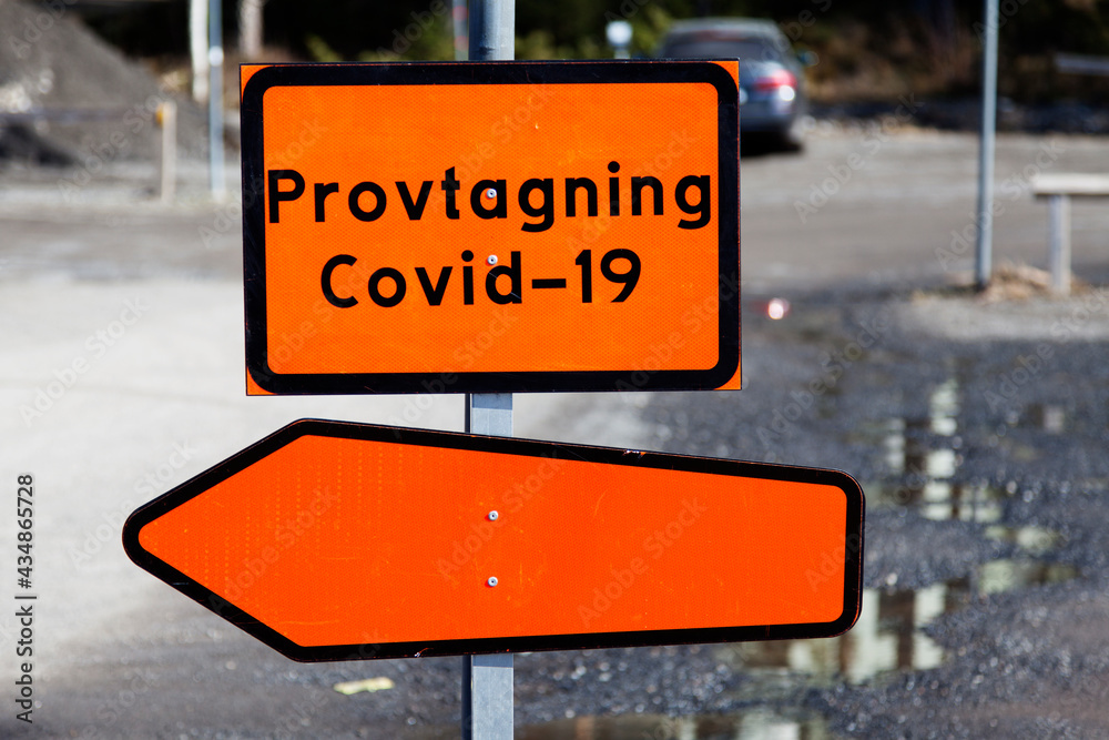 orange sign with the text: sampling covid 19