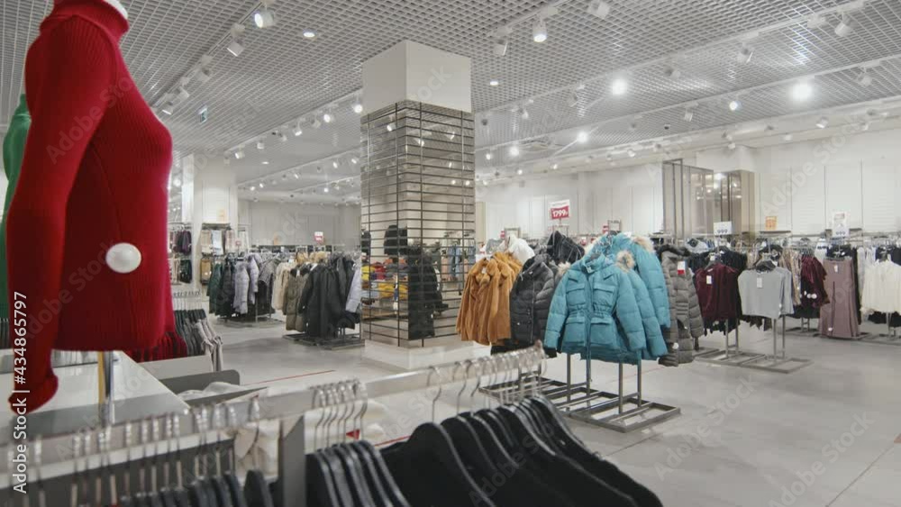 No people overview of indoor women clothing store with outwear and other stylish items
