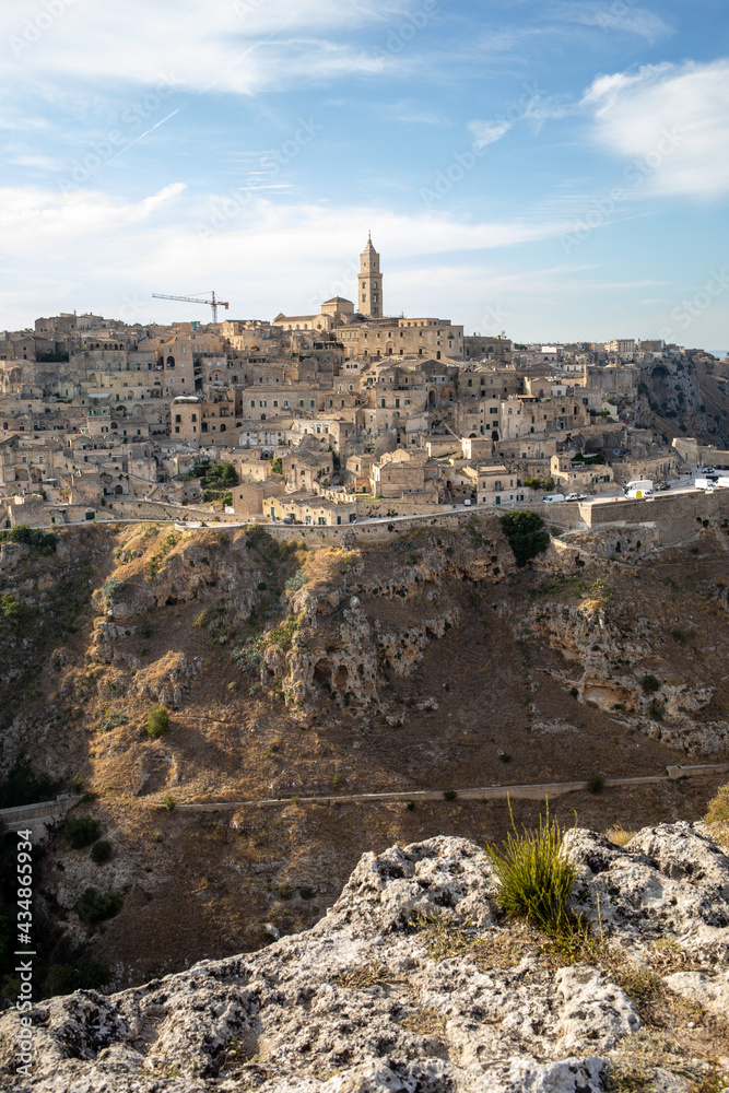 Panoramic view of Sassi di Matera a historic district in the city of Matera, well-known for their ancient cave dwellings from the Belvedere di Murgia Timone, Basilicata, Italy Panoramic view of Sassi di Matera a historic district in the city of Matera, well-known for their ancient cave dwellings from the Belvedere di Murgia Timone, Basilicata, Italy